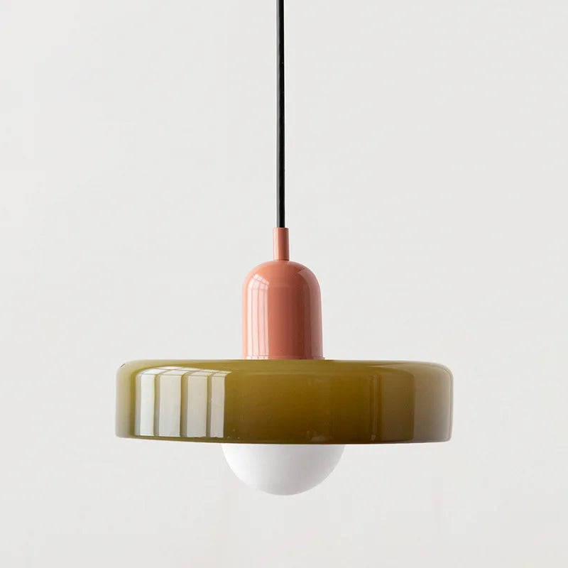 Orange glass pendant hung over a dining table