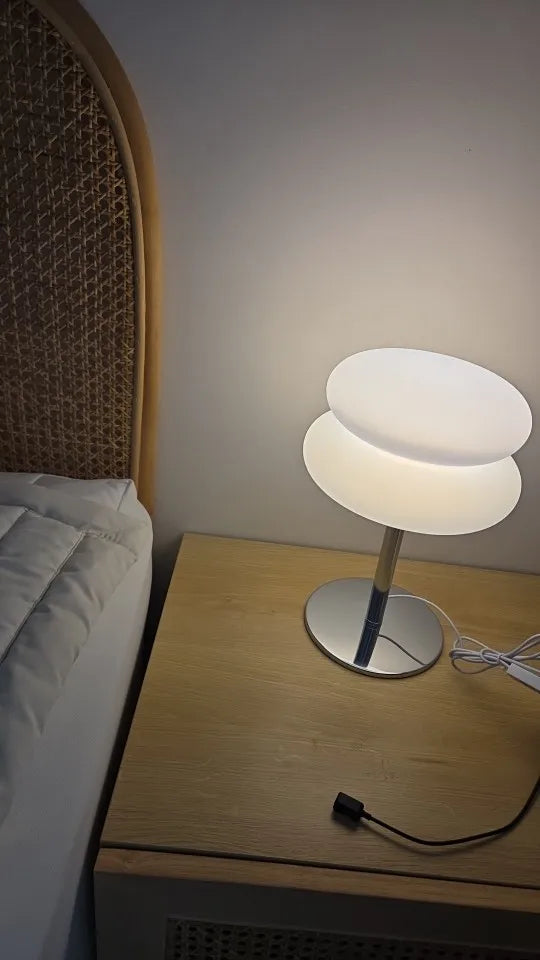 Lamp shown on a desk beside books