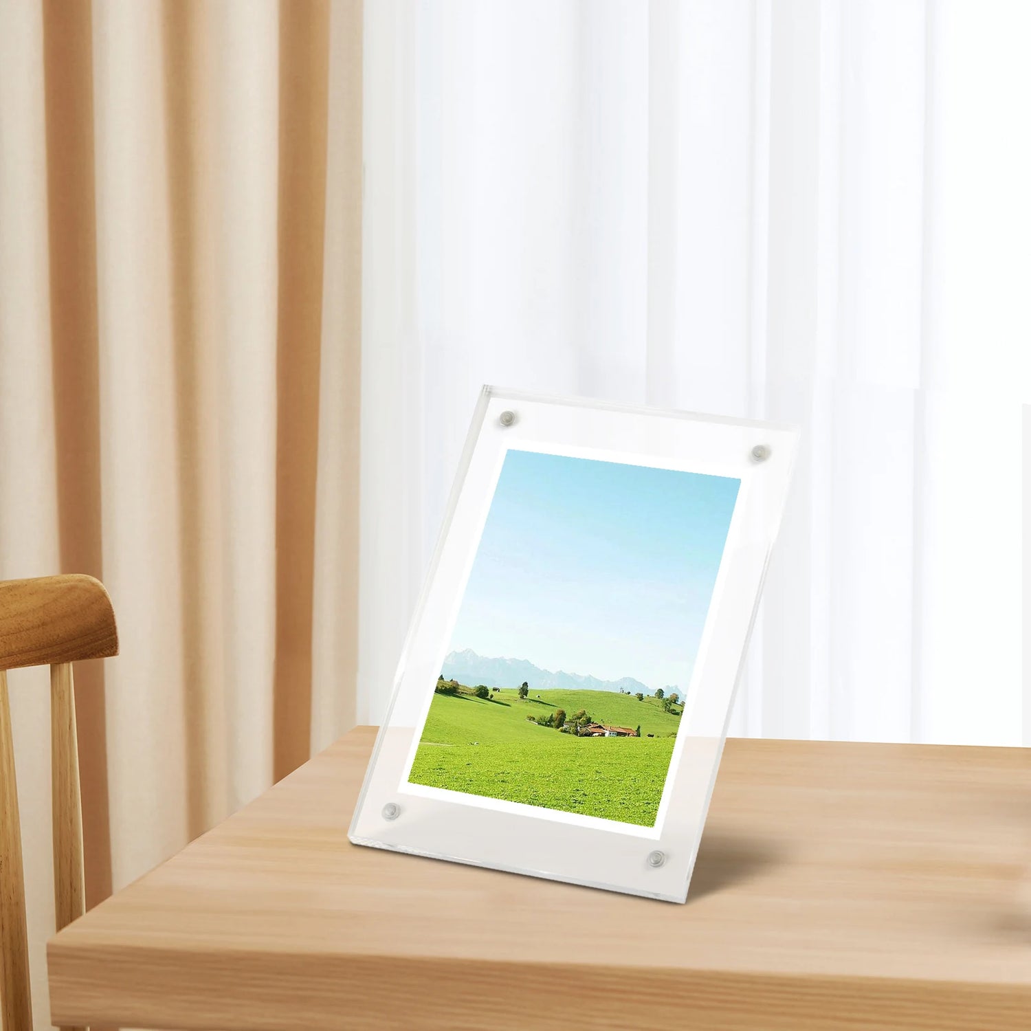 Acrylic photo frame standing on a wooden table