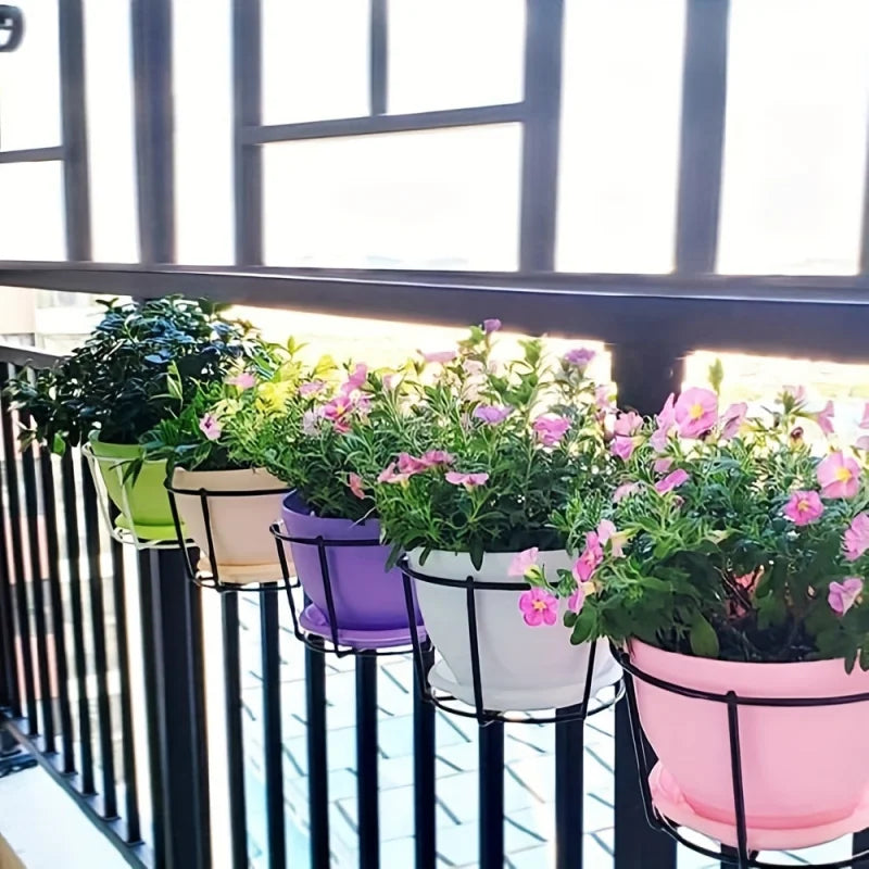 Planters hooked over a balcony rail with flowers