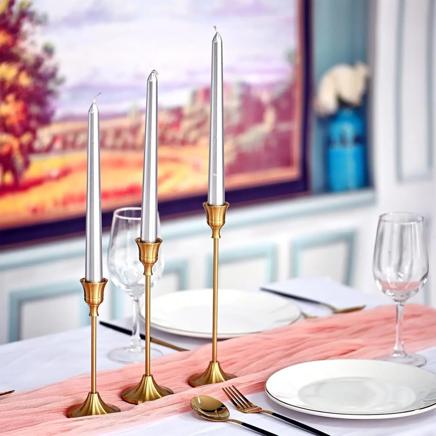 Bronze candle holders with lit dinner candles